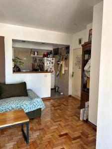 a living room with a couch and a wooden floor at Cálido y luminoso hogar in Vicente López