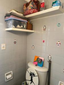 a bathroom with a toilet with a book on it at Cálido y luminoso hogar in Vicente López +12 photos