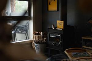 a living room with a fireplace and a window at The Duckling in Glenlyon