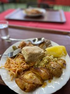 a plate of food with meat and rice on a table at Eskias2 in Garðabær