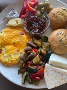 a plate of breakfast food with eggs sausage vegetables and bread at Eskias2 in Garðabær