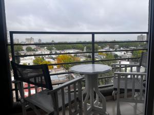a table and chairs on a balcony with a view at Urbano Alem in Coronel Suárez
