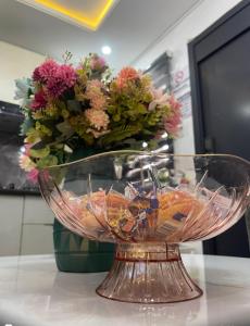 a glass bowl on a counter with a flower arrangement at Luxury home in Lagos