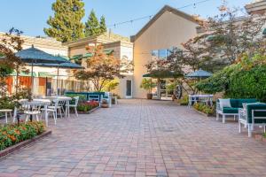 a patio with tables and chairs in a courtyard at Holiday Inn Auburn by IHG in Auburn