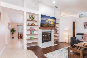 a living room with a fireplace and a couch at The Pelican/Pool/HotTub/GameRoom in Brandon