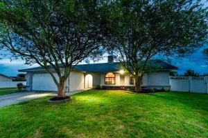 a house with two trees in the yard at The Pelican/Pool/HotTub/GameRoom in Brandon