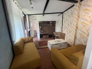 a living room with a couch and a table at Our furnex homes in Pātan