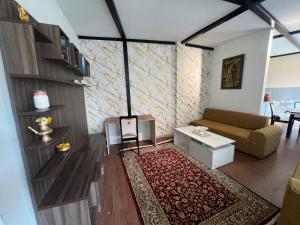 a living room with a couch and a table at Our furnex homes in Pātan