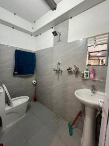 a bathroom with a sink and a toilet at Our furnex homes in Pātan