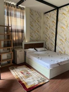 a bedroom with two beds and a rug at Our furnex homes in Pātan