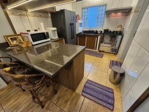 a large kitchen with a counter top in a room at Recanto Luigi in Brotas