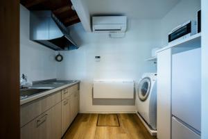 a kitchen with a sink and a washing machine at LadolcevitA - 総檜サウナ - Private Hinoki Sauna Inn in Mitsugoe
