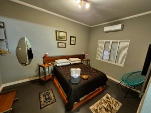 a bedroom with a bed and a television in it at Recanto Luigi in Brotas
