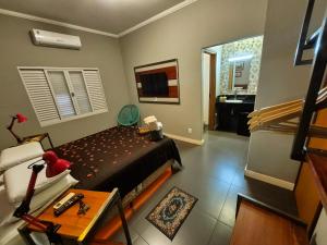 a small bedroom with a bed and a bathroom at Recanto Luigi in Brotas