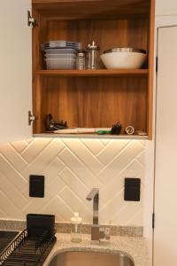 a kitchen counter with a sink and a shelf at Calle y Número, San Felipe in Guadalajara +118 photos