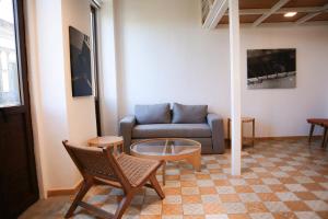 a living room with a couch and a coffee table at Calle y Número, San Felipe in Guadalajara