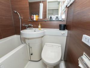 a bathroom with a toilet and a sink and a bath tub at The BREAKFAST HOTEL PORTO Ishigakijima in Ishigaki Island +55 photos