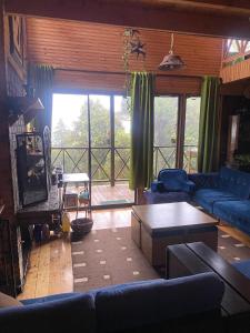 a living room with a couch and a table at Cabaña Facovi in Empalme