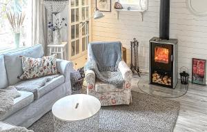 a living room with a couch and a fireplace at Amazing Home In Luleå With Sauna in Luleå