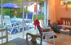 a living room with a patio with a table and chairs at Amazing Home In Luleå With Sauna in Luleå