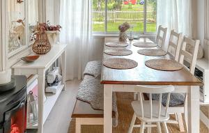 a dining room with a table with chairs and a tableablish at Amazing Home In Luleå With Sauna in Luleå +17 photos