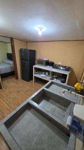 a room being remodeled with a kitchen and a living room at Hummingbird Morfus Lodge in Tilarán