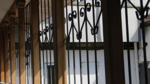 a window with black wrought iron bars on it at Casa Hotel la Alsacia in Santa Rosa de Cabal