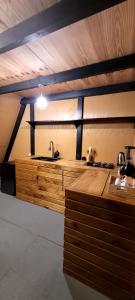 a kitchen with a sink and a wooden counter at Chalé in Alfredo Wagner