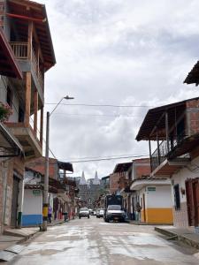a city street with cars driving down a street with buildings at Hostal Rose Moor in Jardin