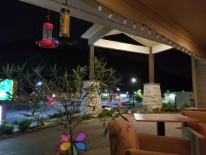 a patio at night with a table and lights at Rolling Hills Lodge in Cherokee