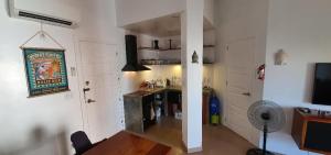 a room with a kitchen and a living room with a fan at Scandi Apartment Boracay by Simple Realty Management in Boracay