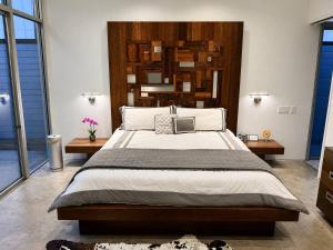a bedroom with a large bed with a wooden headboard at Luxury 2BR 2BA w Pool and Large Pets Allowed in Dallas +18 photos