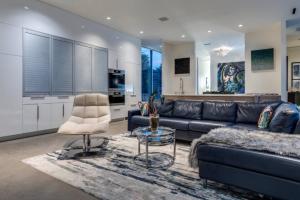 a living room with a couch and a table and a kitchen at Luxury 2BR 2BA w Pool and Large Pets Allowed in Dallas
