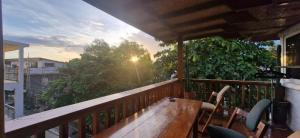 a deck with a wooden bench on a balcony at Scandi Apartment Boracay by Simple Realty Management in Boracay