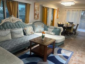 a living room with a couch and a table at The KentiGate - much more than a room in Nuku‘alofa