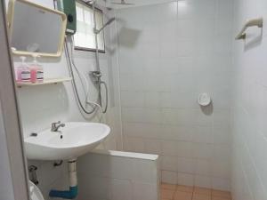 a white bathroom with a sink and a shower at Little house in Koh Samui