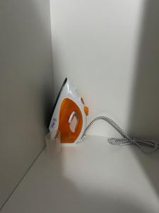 an orange phone is plugged into a wall at Ap Aconchego in Campinas