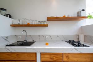 a kitchen with a sink and a counter top at Villa Camille - Private 1BR Oasis with Pool in Nyanyi Beach in Tanah Lot +30 photos