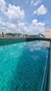 a large swimming pool with blue tiles on it at Ap Tryp by Wyndham Nações in Brasília
