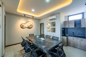 a dining room with a table and chairs at Front One Budget Hotel Tirtonadi Solo in Solo