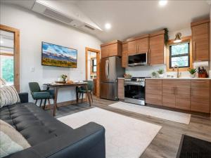a kitchen with a couch and a table in a room at Alpenhaus | Ski Jackson & Targhee in Victor
