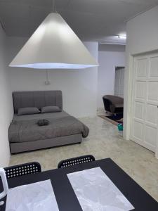 a living room with a couch and a table at DNH Nilam Puri Homestay Unit C in Kota Bharu