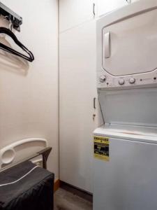 a kitchen with a white refrigerator and a microwave at Alpenhaus | Ski Jackson & Targhee in Victor