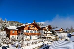 a home in the snow with snow covered trees at Appartements Rettensteiner in Schladming