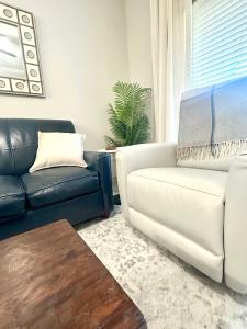 a living room with a couch and a chair at Walk to Stadium & Cotton District, Balcony & Pool in Starkville +16 photos