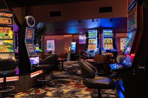 a casino with several slot machines in a room at Coomera Lodge Hotel in Gold Coast