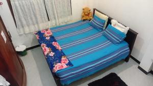 a bed with a teddy bear sitting on top of it at RanaHansa Villa in Kegalle
