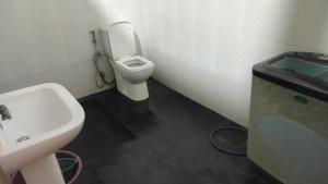 a bathroom with a white toilet and a sink at RanaHansa Villa in Kegalle +60 photos