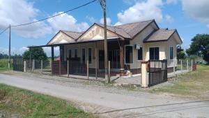 a house being constructed on the side of a road at D'Shazly Homestay Village in Arau