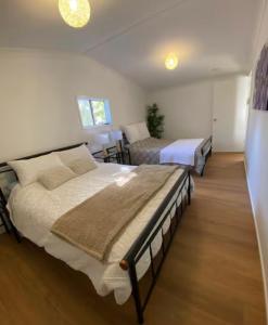 a bedroom with two beds in a room at Amoré Cabin in Ocean View